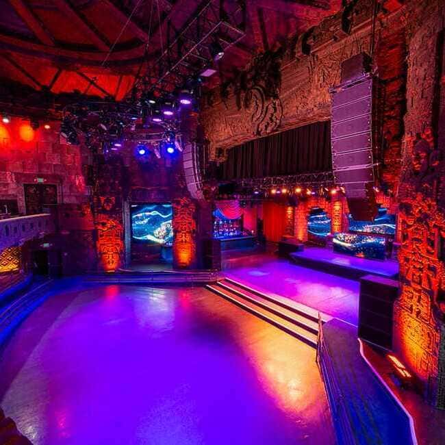 The Mayan's main stage lit in purple and red